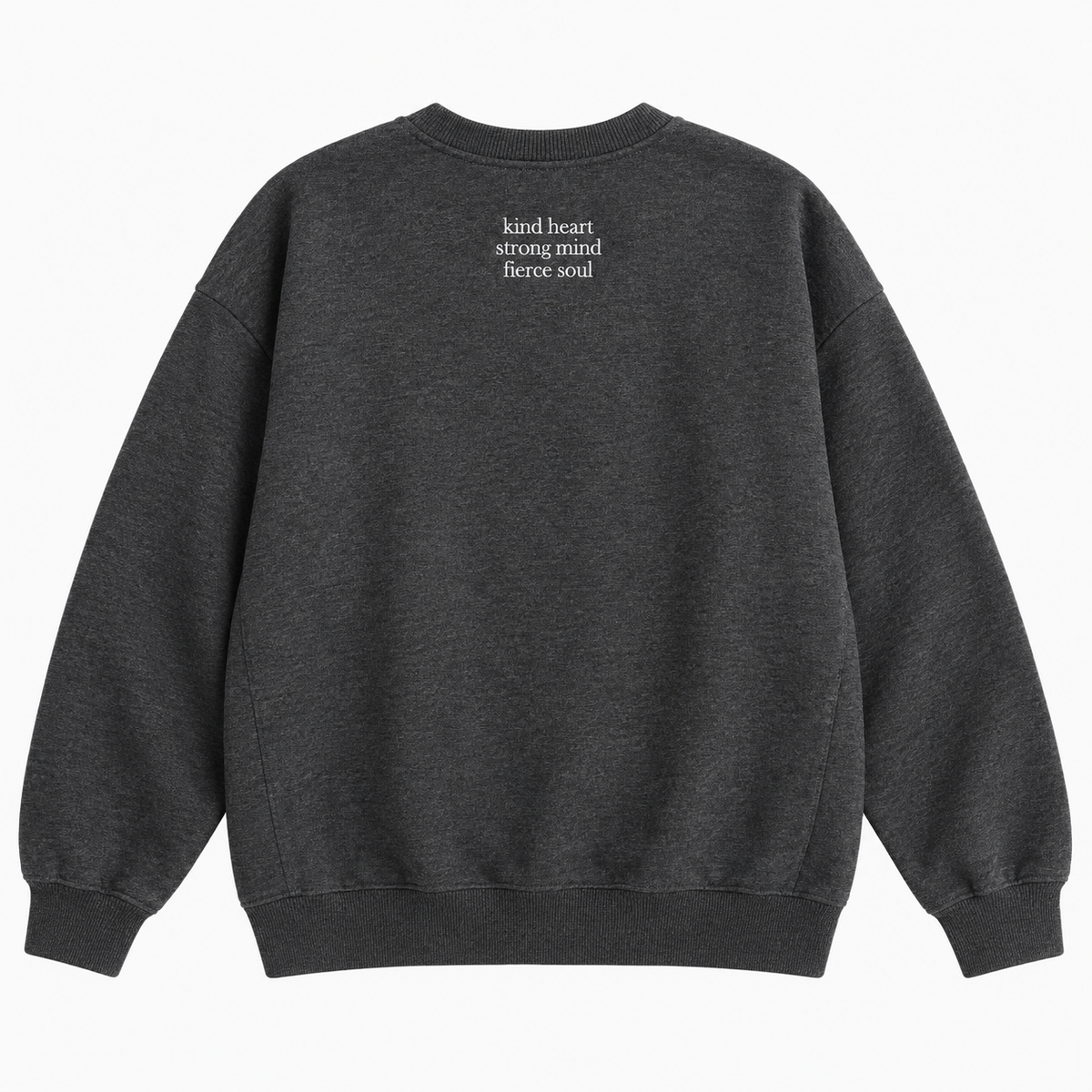 A dark heather gray crewneck sweatshirt shown from the back, featuring the text 'kind heart strong mind fierce soul' printed in small white letters on the upper back, set against a plain white background.