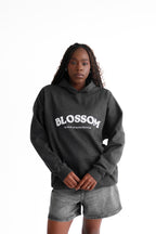 Grey blossom hoodie. Recycled hoodie, black model, oversized hoodie, empowering brand.