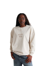 Model wearing Erin sweatshirt in sand, front view.