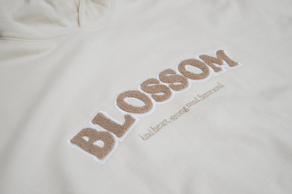 close up of details of beige jade hoodie in sand from blossom featuring the quote kind heart strong mind fierce soul