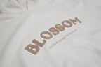 close up of details of beige jade hoodie in sand from blossom featuring the quote kind heart strong mind fierce soul