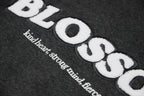 Details close up of charcoal hoodie blossom